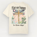 Beige t-shirt with a cross design and text on a light gray background