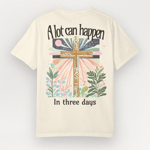 Beige t-shirt with a cross design and text on a light gray background