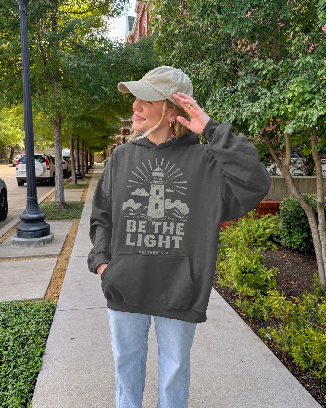 Faith hoodie with lighthouse design and Matthew 5:14 scripture. Christian hoodie for women reminding believers to shine their light.