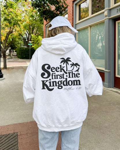 Woman wearing white Seek First the Kingdom Christian hoodie outdoors
