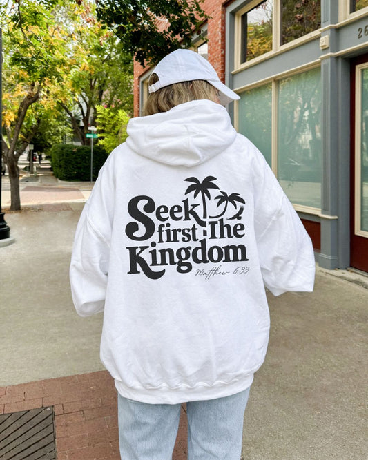 Woman wearing white Seek First the Kingdom Christian hoodie outdoors