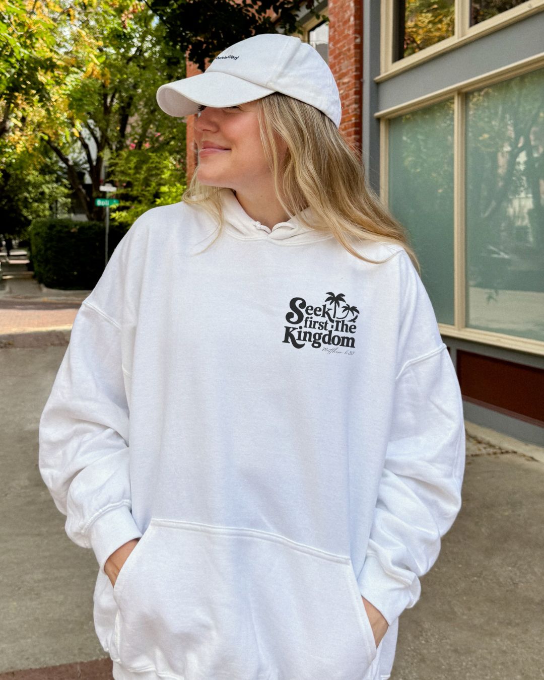 Woman wearing white Seek First the Kingdom Christian hoodie outdoors