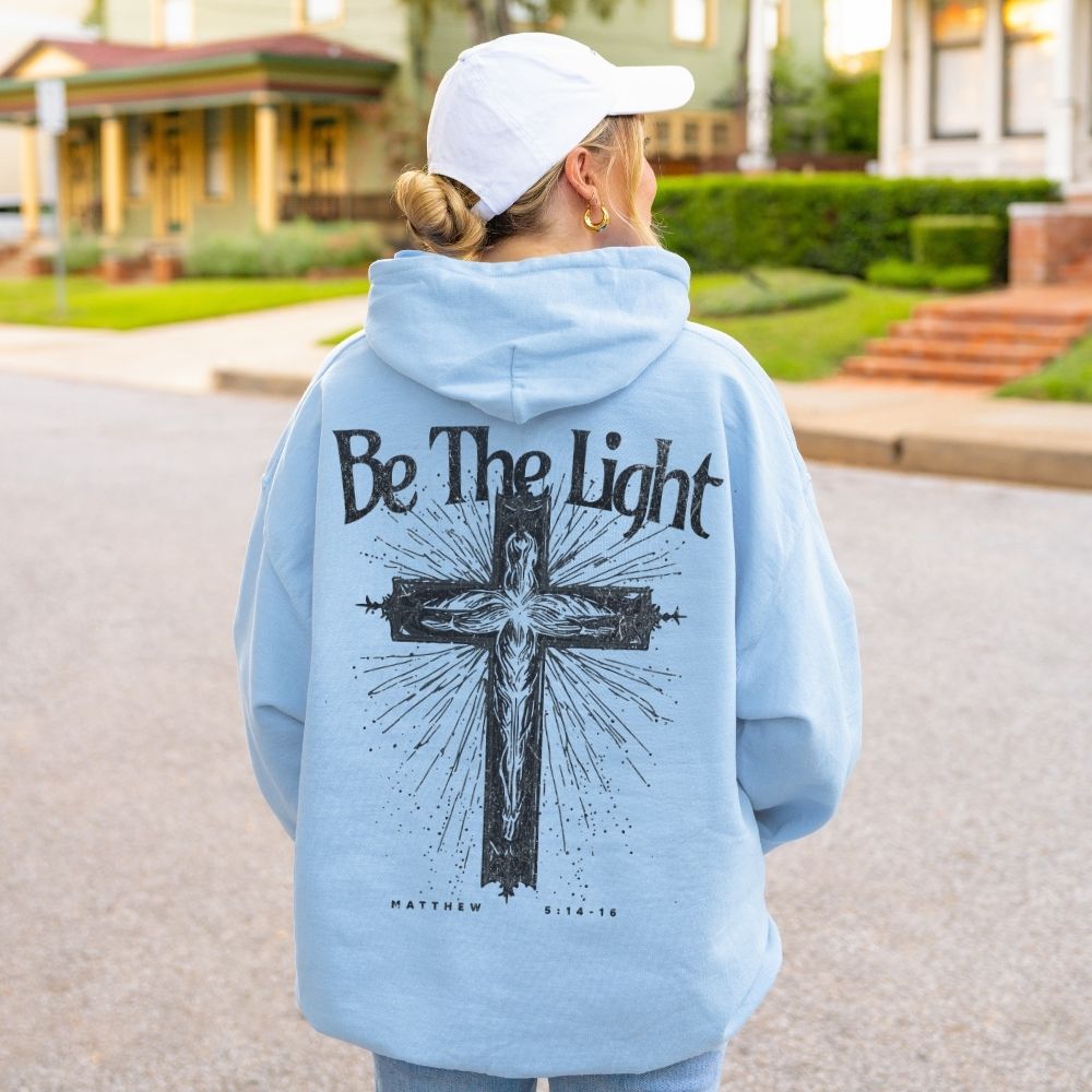 Light blue Christian hoodie with Be The Light cross design