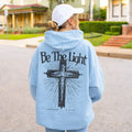 Light blue Christian hoodie with Be The Light cross design