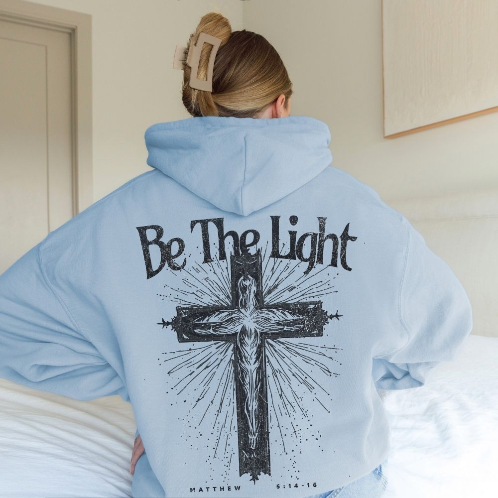 Light blue Christian hoodie with Be The Light cross design
