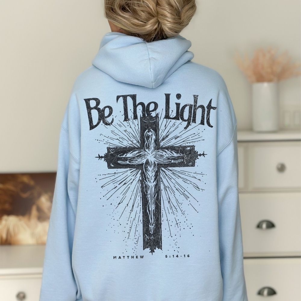 Light blue Christian hoodie with Be The Light cross design