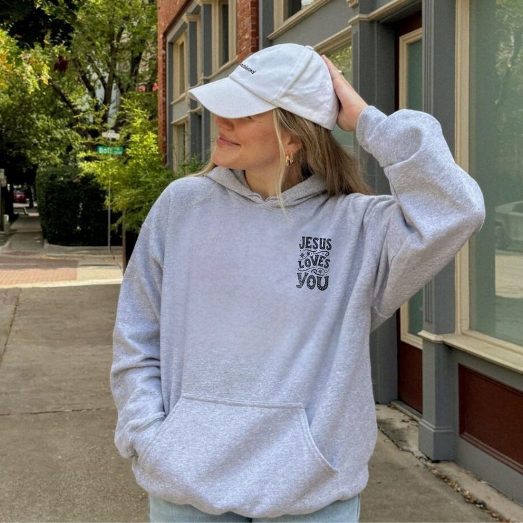 Unisex premium hoodie styled casually with a cap and streetwear look