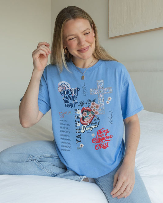 Woman wearing blue Worship While You Wait Christian t-shirt