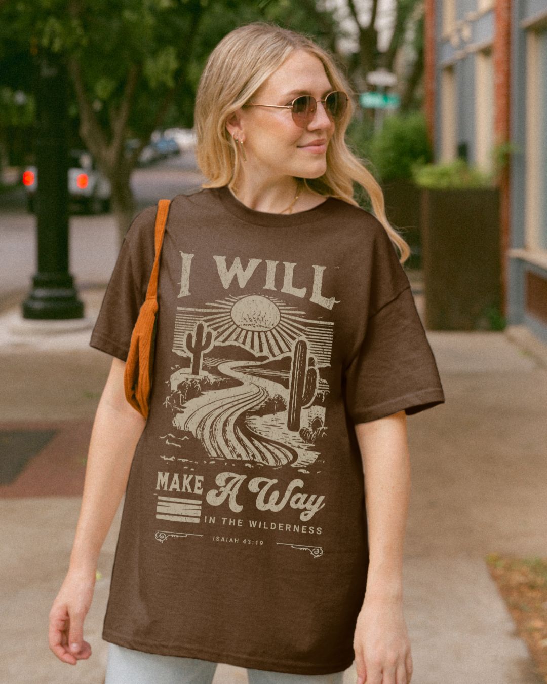 Woman wearing brown I Will Make a Way Christian t-shirt outdoors