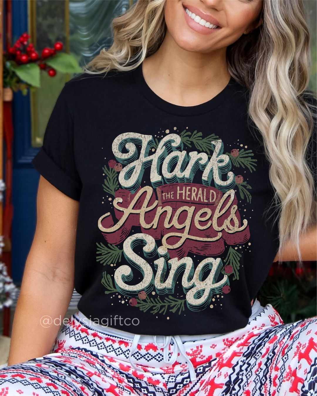 Woman wearing Hark the Herald Angels Sing Christian T-shirt — festive design with holiday greenery celebrating Jesus and Christmas joy.
