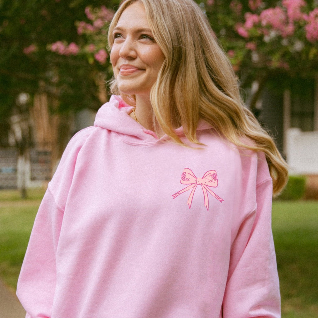 Woman wearing pink God Says You Are Christian hoodie outdoors