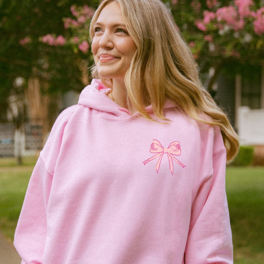 Woman wearing pink God Says You Are Christian hoodie outdoors