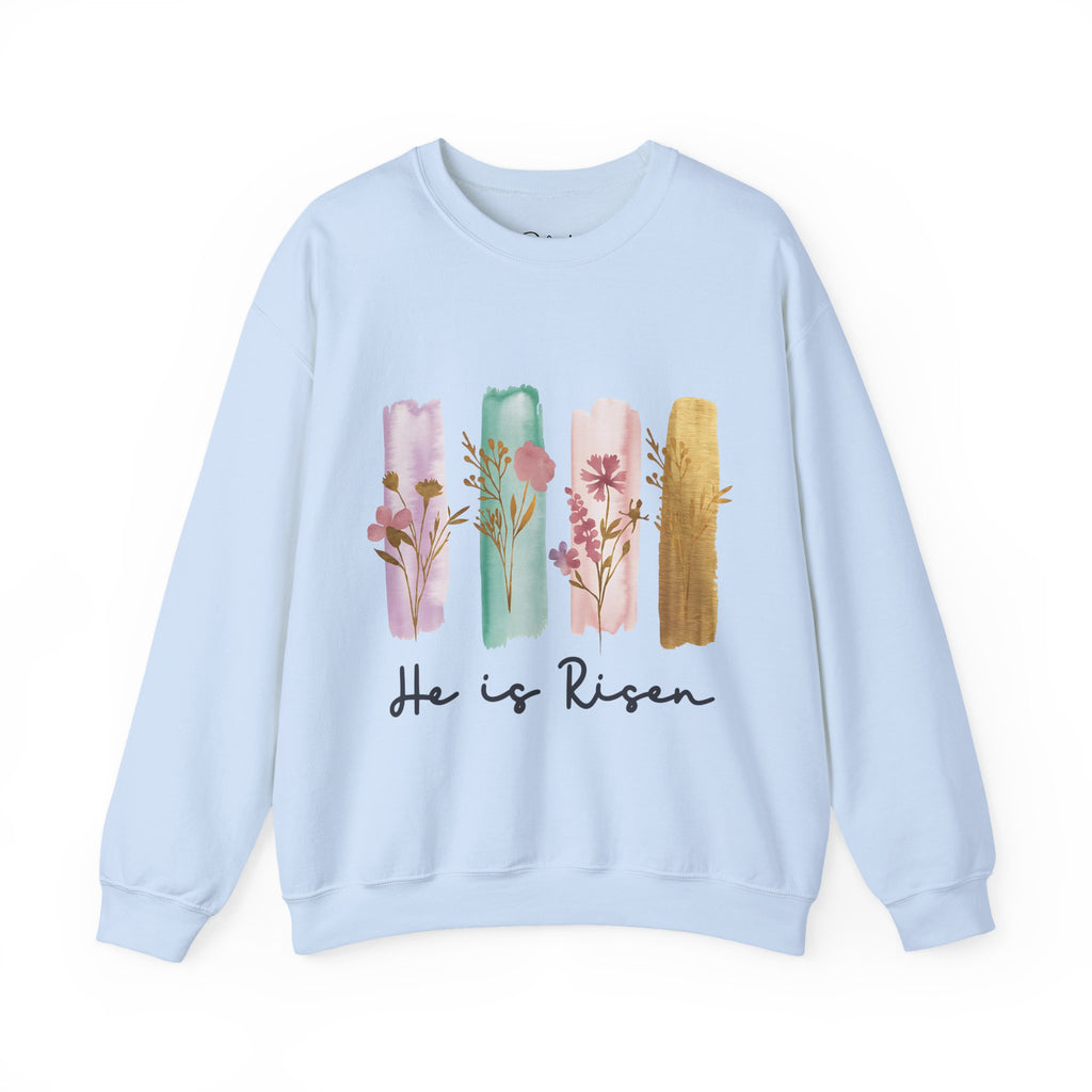 Light blue sweatshirt with floral design and 'He is Risen' text on a white background