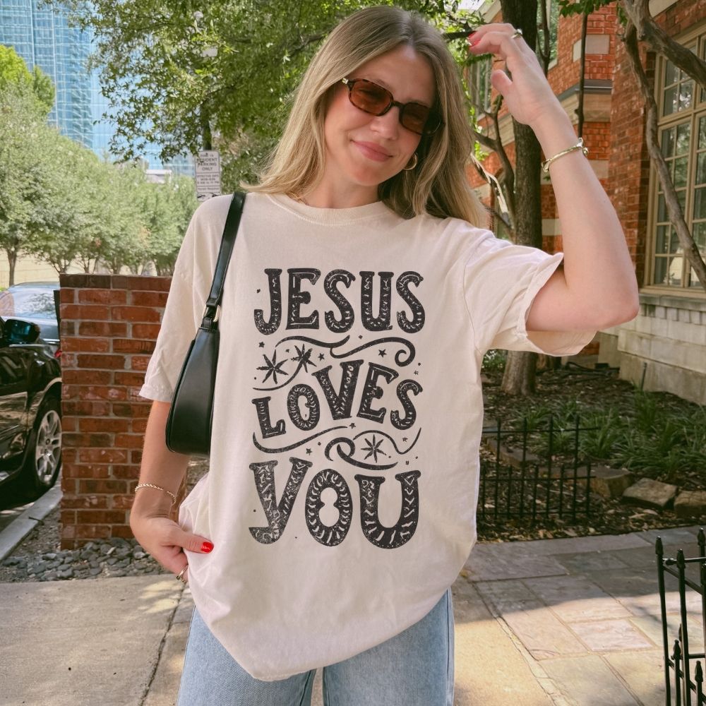 Woman wearing Jesus Loves You Christian t-shirt outdoors