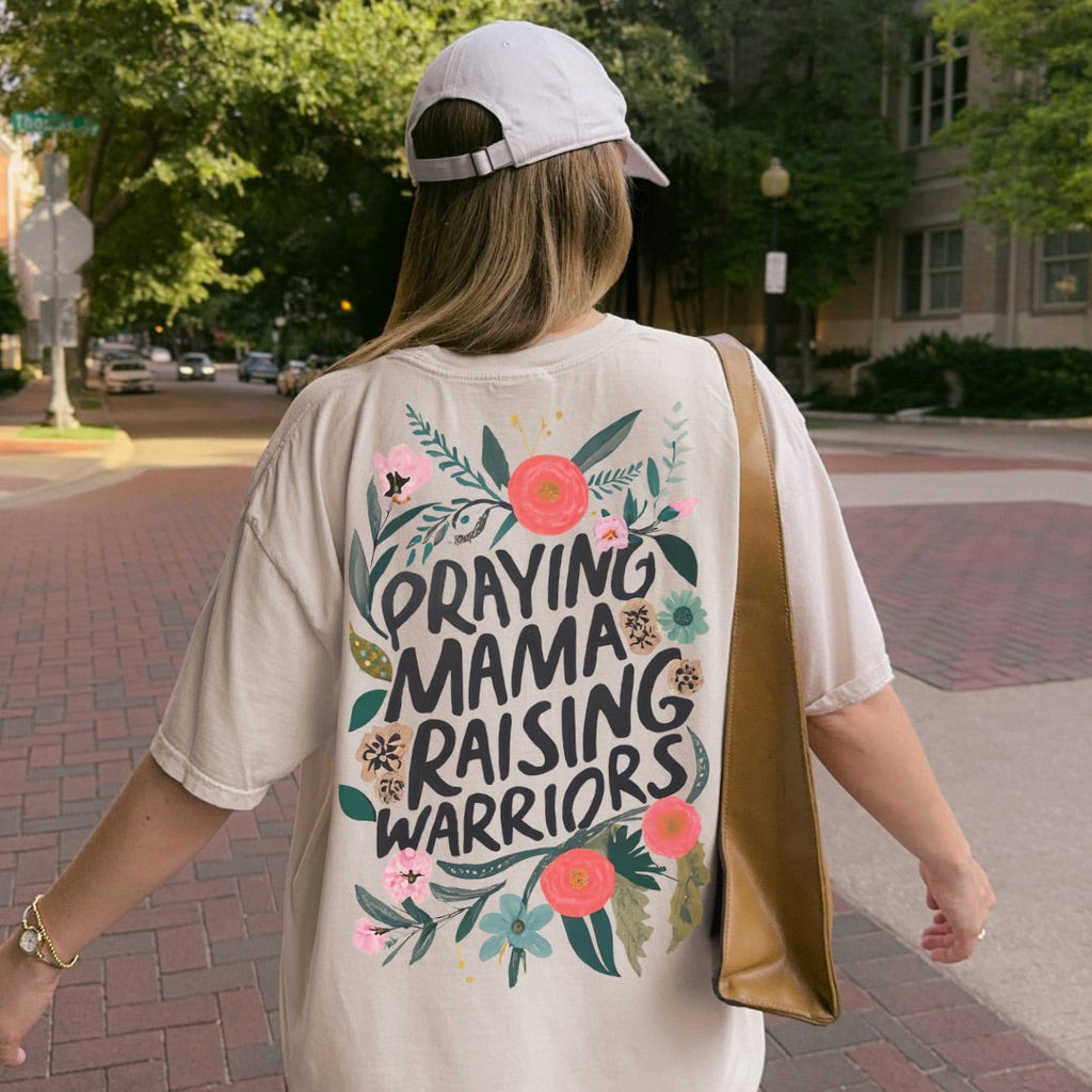 Woman wearing Praying Mama Raising Warriors Christian t-shirt
