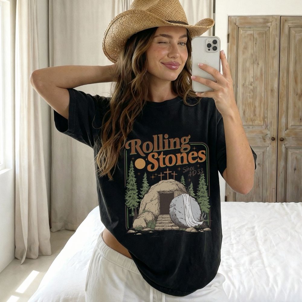 Person wearing a black 'Rolling Stones' t-shirt in a bedroom setting