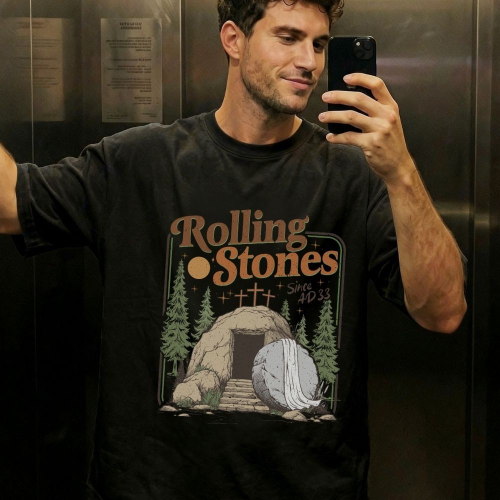 Man taking a mirror selfie wearing a Rolling Stones t-shirt in an elevator.