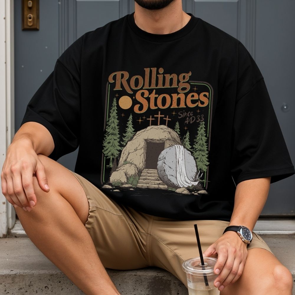 Person wearing a white sweatshirt with floral design and text, holding iced coffee.