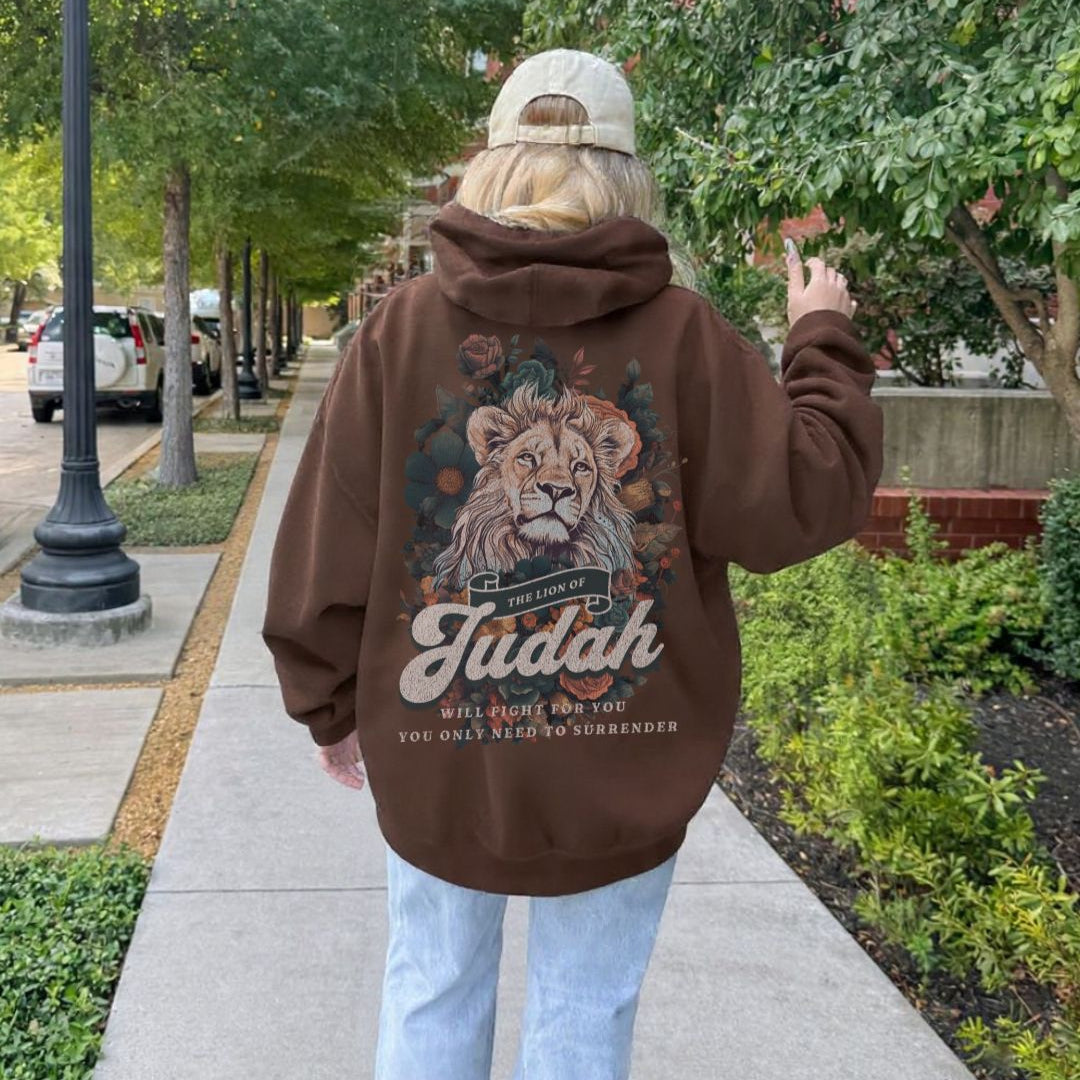Back view of brown hoodie featuring Lion of Judah artwork with floral details and scripture inspired text