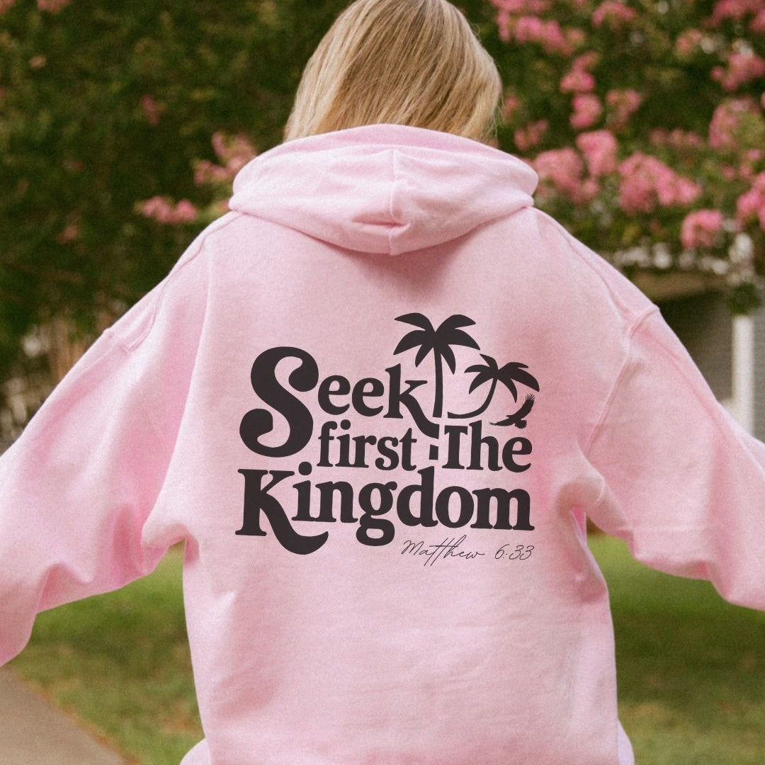 Back view of a pink faith-inspired hoodie with “Seek First the Kingdom” design