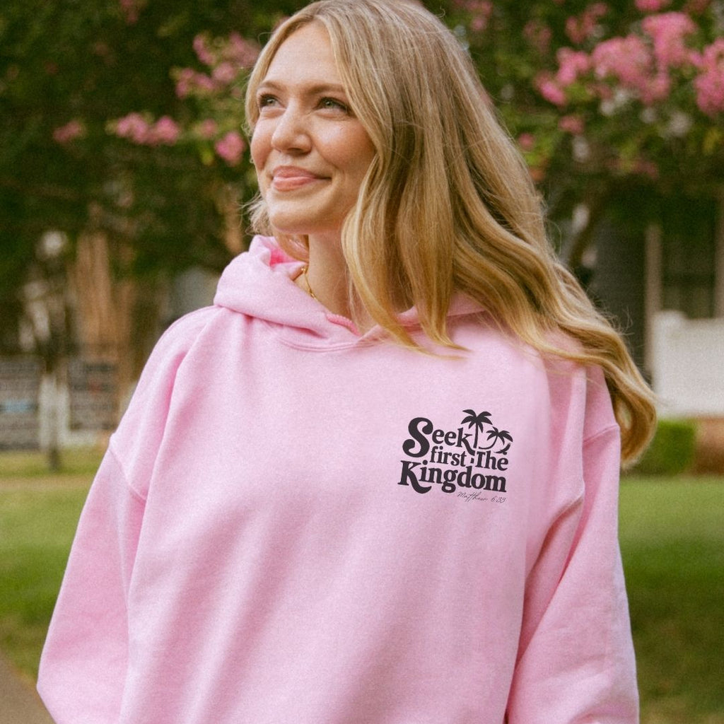 Back view of a pink faith-inspired hoodie with “Seek First the Kingdom” design
