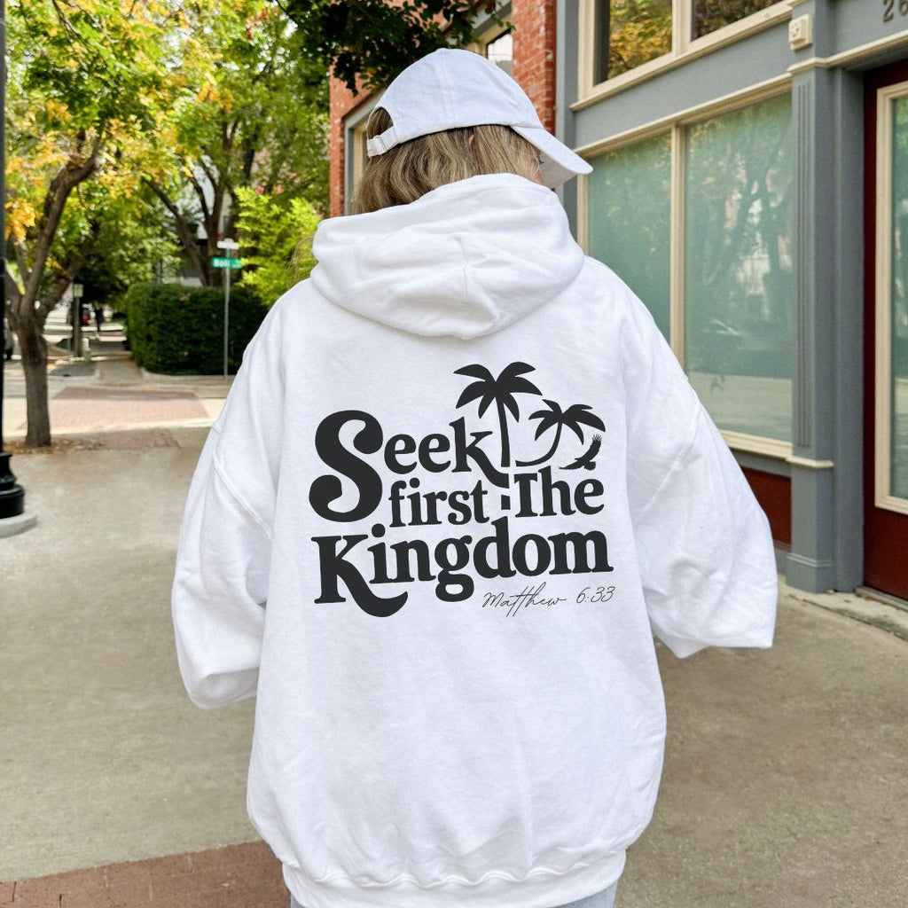 Woman wearing white Seek First the Kingdom Christian hoodie outdoors