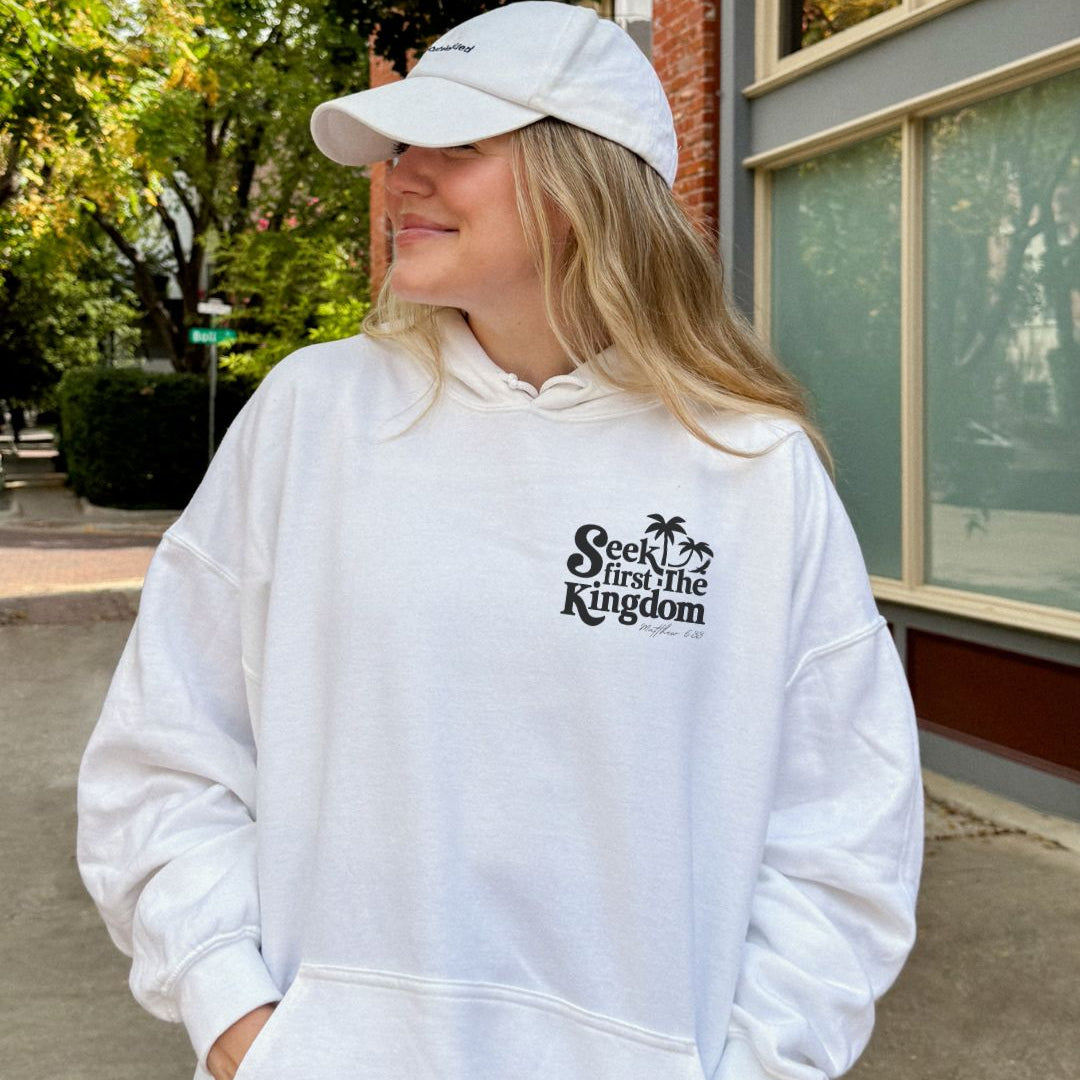 Woman wearing white Seek First the Kingdom Christian hoodie outdoors
