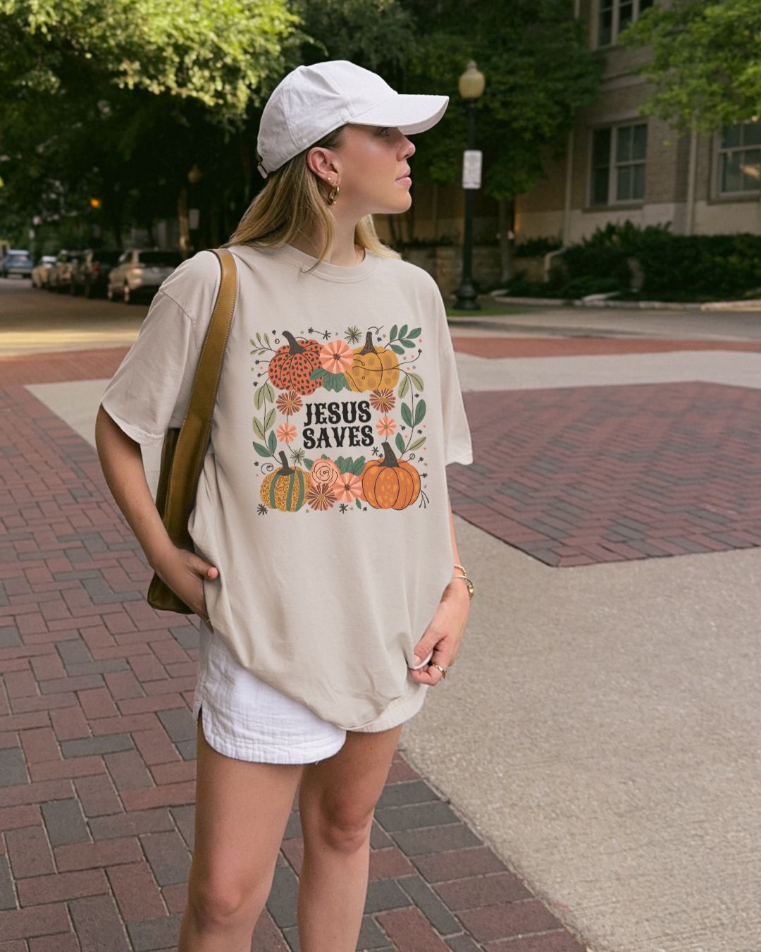 Woman wearing cream Jesus Saves Christian t-shirt outdoors