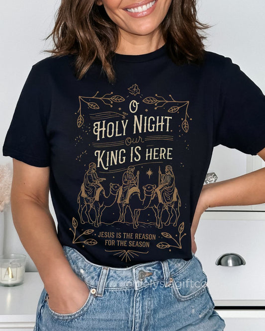 Woman wearing O Holy Night Our King Is Here Christian T-shirt with three wise men design — faith-based Christmas apparel celebrating Jesus.