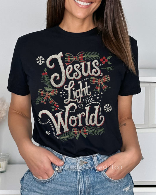 Woman wearing Jesus, Light of the World Christian Christmas T-shirt — plaid bow design celebrating the light of Jesus.