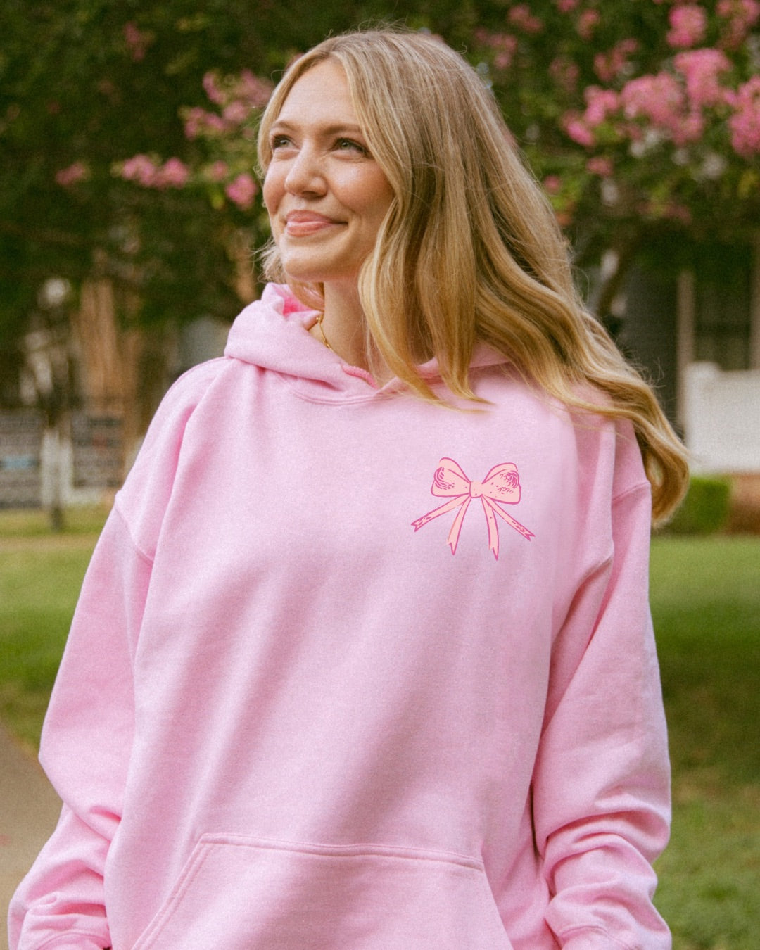 Woman wearing pink God Says You Are Christian hoodie outdoors
