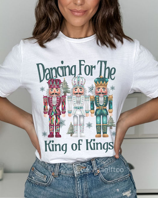 Woman wearing Dancing for the King of Kings Christian Christmas T-shirt with festive nutcracker design — joyful faith apparel celebrating Jesus.