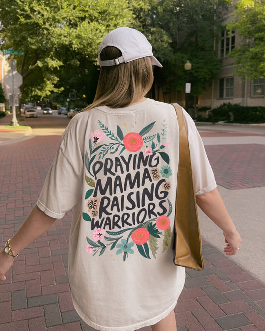 Woman wearing Praying Mama Raising Warriors Christian t-shirt