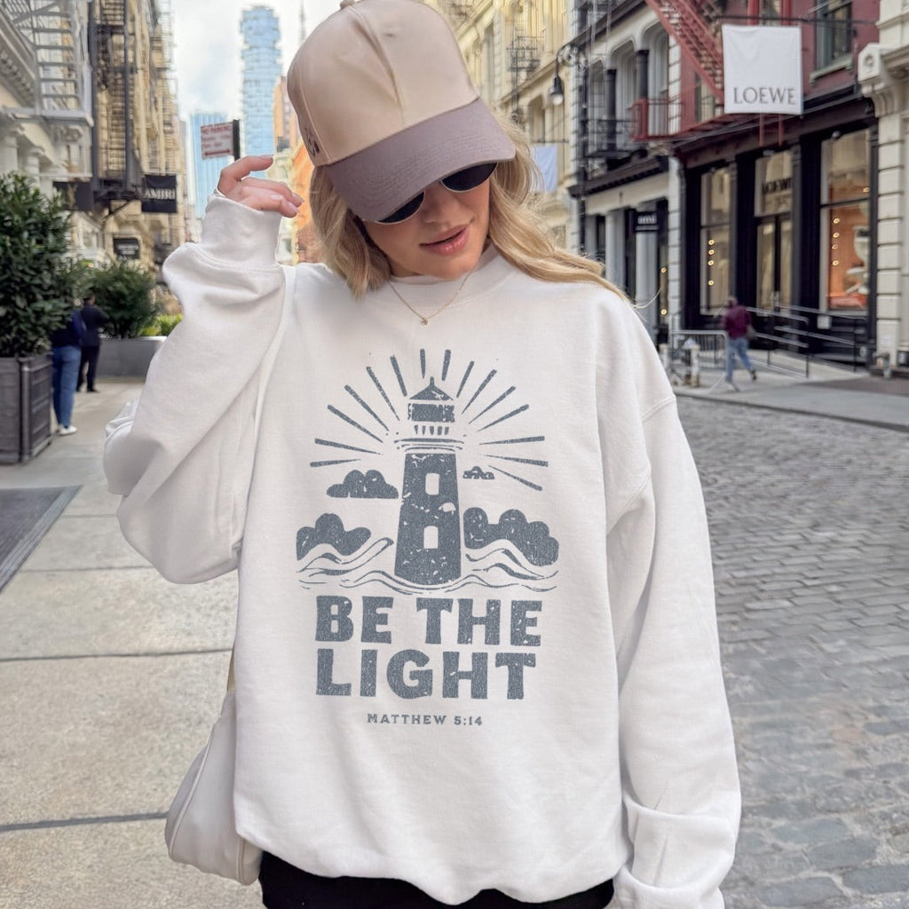 Faith sweatshirt with lighthouse and Matthew 5:14 design. Christian sweatshirt encouraging them to be the light