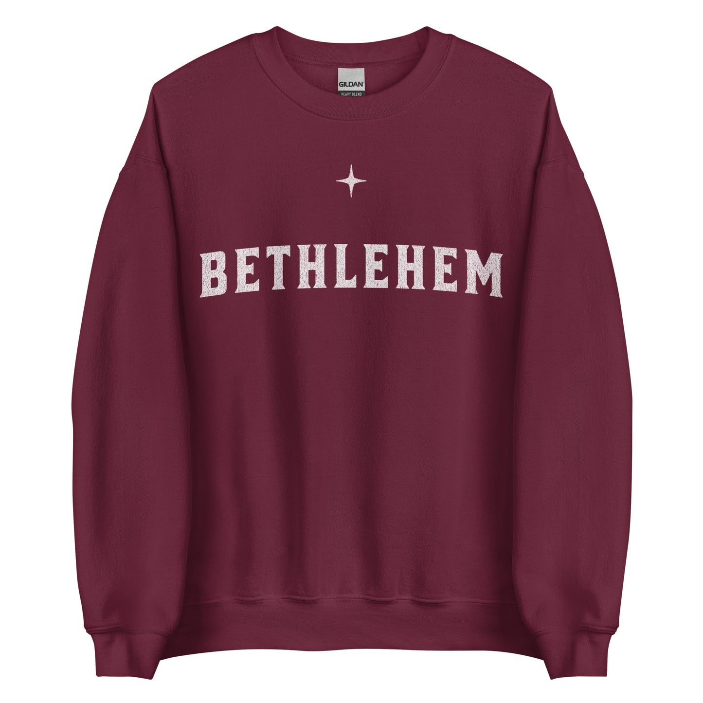 Woman wearing dark green Bethlehem Christian Christmas sweater with simple star design.