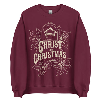Woman wearing burgundy Christ Our Christmas sweater with manger and poinsettia design.