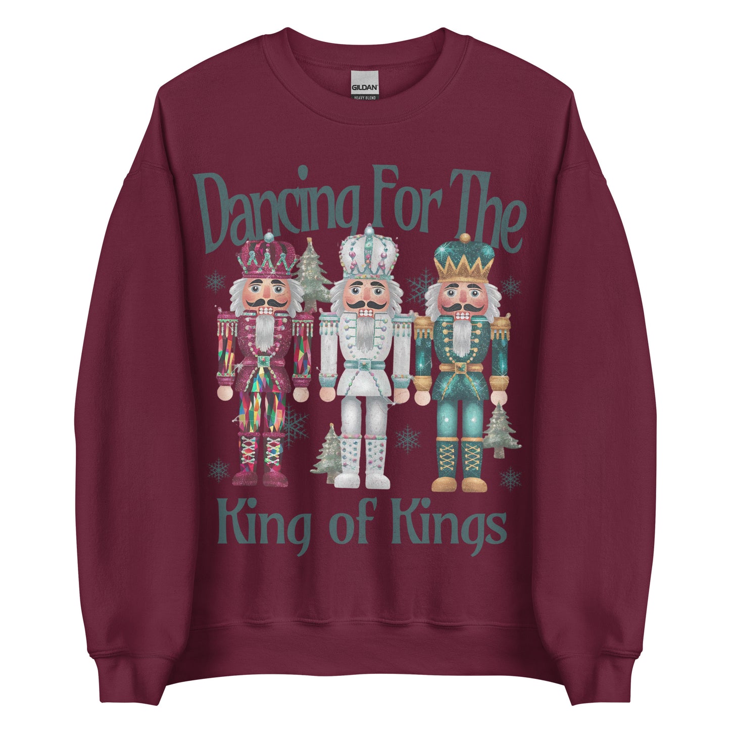 Woman wearing Dancing for the King of Kings Christian Christmas sweater with three colorful nutcracker figures.