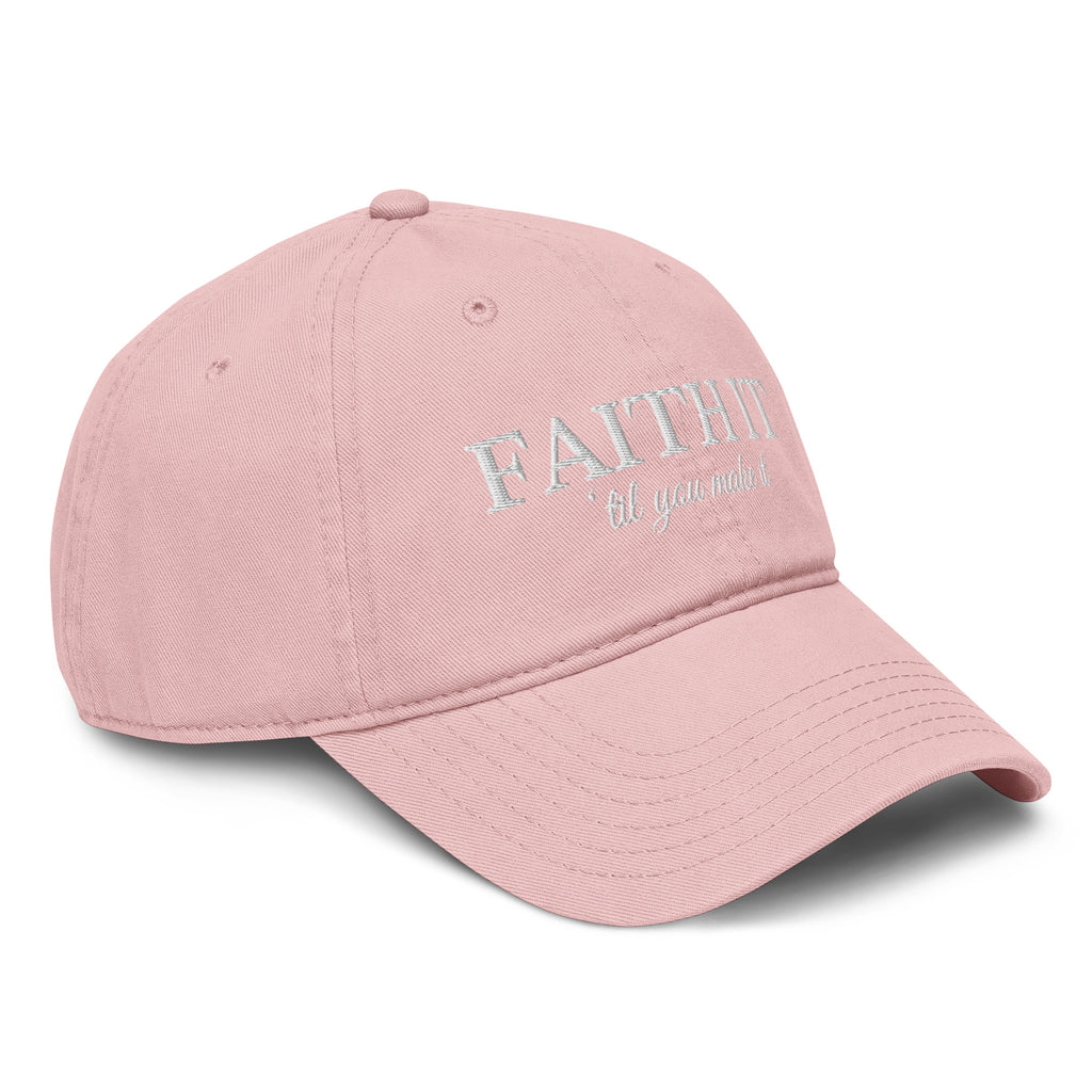 Woman wearing blush Faith It Til You Make It Christian embroidered baseball cap with neutral sweater and gold necklace.