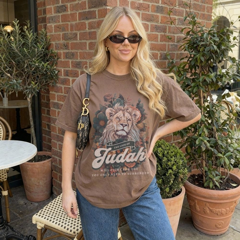 Woman wearing a Lion of Judah Christian t-shirt artwork with lion illustration and scripture text