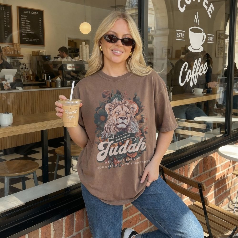 Woman wearing a Lion of Judah Christian t-shirt artwork with lion illustration and scripture text