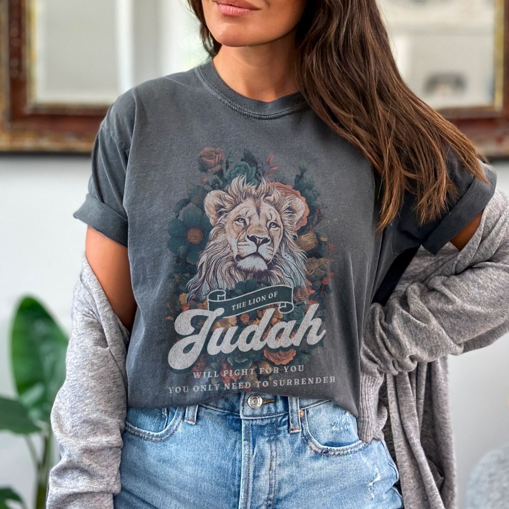 Faith t-shirt with lion design and scripture from Exodus and Revelation. Christian women’s t-shirt symbolizing victory and strength in faith