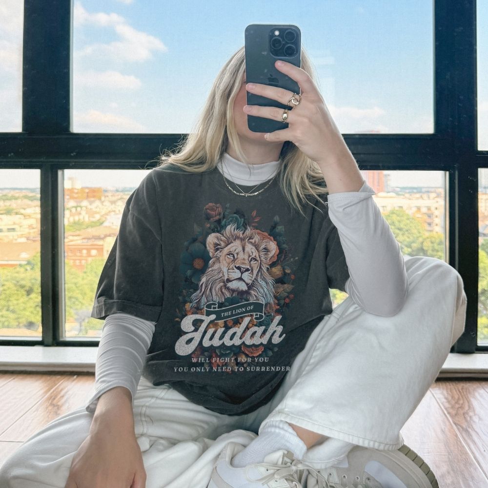 Faith t-shirt with lion design and scripture from Exodus and Revelation. Christian women’s t-shirt symbolizing victory and strength in faith