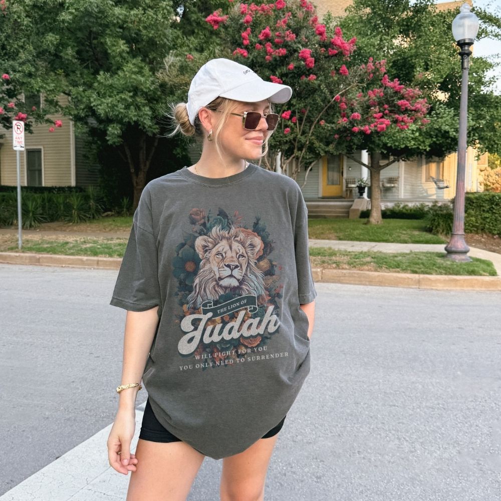 Faith t-shirt with lion design and scripture from Exodus and Revelation. Christian women’s t-shirt symbolizing victory and strength in faith