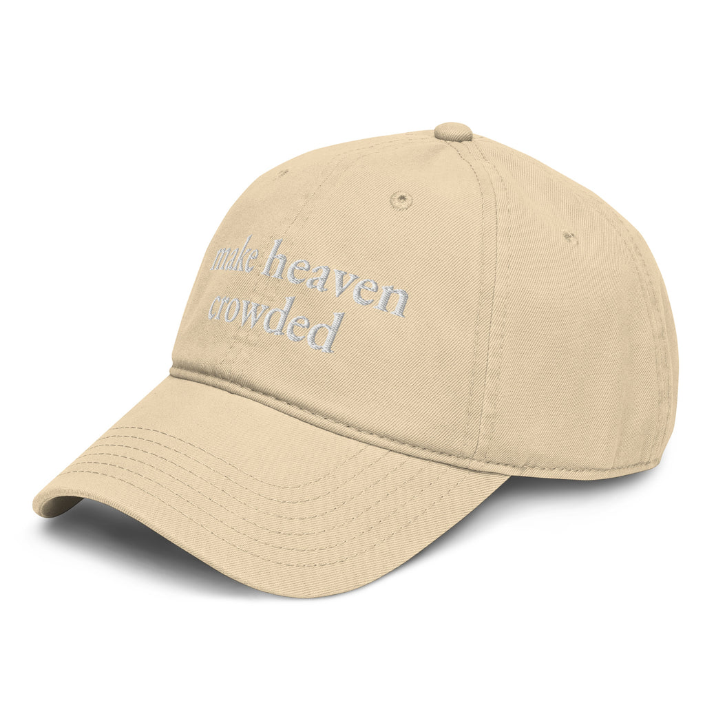 Woman wearing beige Make Heaven Crowded embroidered Christian baseball cap with neutral outfit.