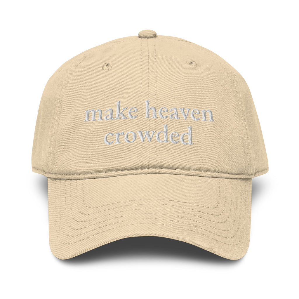 Woman wearing beige Make Heaven Crowded embroidered Christian baseball cap with neutral outfit.