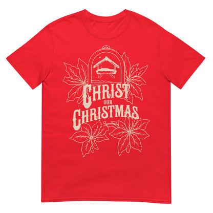 Woman wearing Christ Our Christmas Christian T-shirt with nativity design and poinsettias — faith-based apparel celebrating Jesus this holiday.
