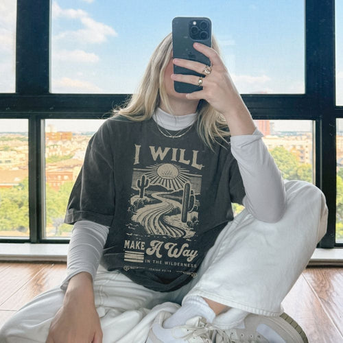 A faith-inspired Christian tee featuring Isaiah 43:19. Designed to remind you that God makes a way, even in the wilderness.